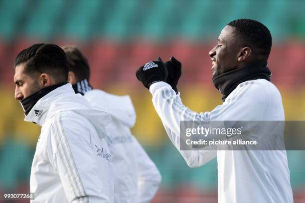 Germany's Antonio Rudiger laughing during warm-up during the German national soccer squad's training at the Friedrich Ludwig Jahn sports park in...