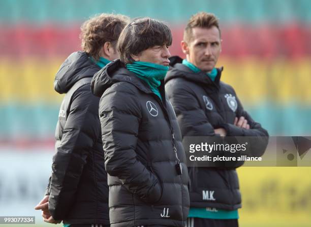 Intern Miroslav Klose and Germany head coach Jogi Low observing the German national soccer squad's training at the Friedrich Ludwig Jahn sports park...