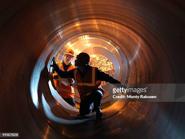 engineers inspecting forged steel - steel industry stock-fotos und bilder