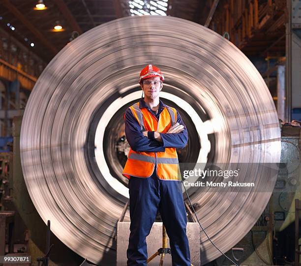 engineer in front of steel lathe - man and machine fotografías e imágenes de stock