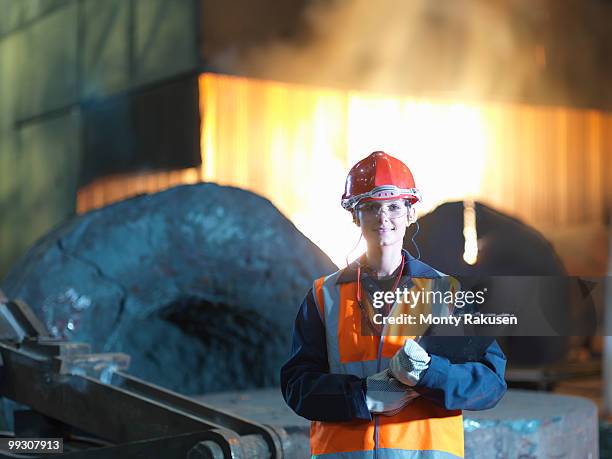 portrait of female steel engineer - metal grate foto e immagini stock