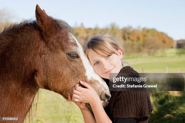 girl stroking a horse - dießen stock-fotos und bilder