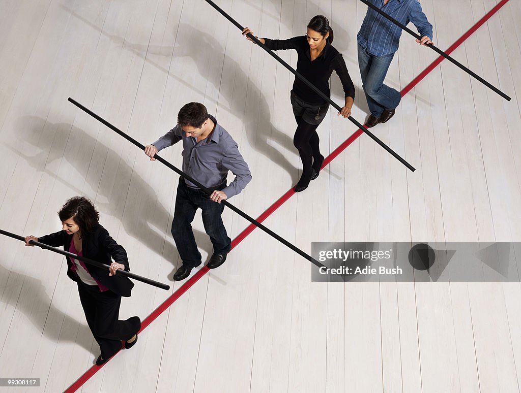 People balancing on thin red line