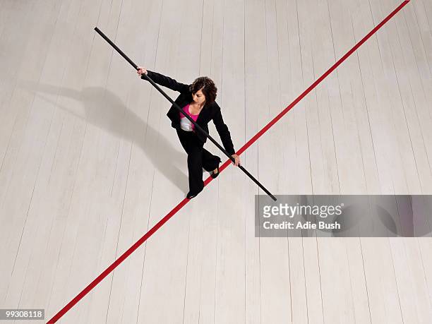 business woman balancing on red line - tightrope walking stock-fotos und bilder