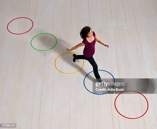 woman jumping over circles - leap forward stock pictures, royalty-free photos & images