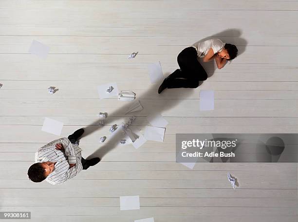 business man standing over woman - overdoing stock pictures, royalty-free photos & images