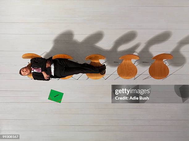 business man sitting on chair reading - overdoing stock pictures, royalty-free photos & images