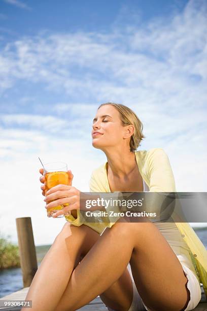 woman enjoying a cold drink - hermanus stock pictures, royalty-free photos & images