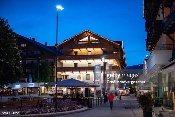 tourists and locals taking a stroll through the streets of seefeld, austria. - seefeld stock pictures, royalty-free photos & images