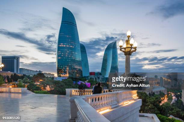 the flame towers at night seen from the dagustu park in baku,azerbaijan - baku stock pictures, royalty-free photos & images