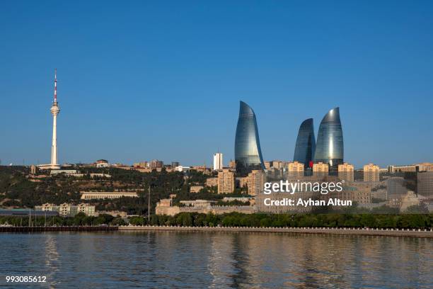 the flame towers and caspian sea  from  baku's boulevard park in the early morning,azerbaijan - baku stock pictures, royalty-free photos & images