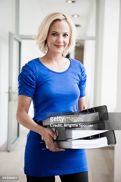 woman carrying files - brigitte sporrer stock pictures, royalty-free photos & images