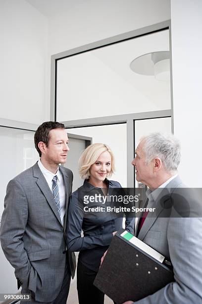 3 business people meeting - brigitte sporrer stock pictures, royalty-free photos & images