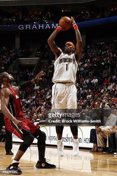Stephen Jackson of the Charlotte Bobcats shoots a jump shot against Dwyane Wade of the Miami Heat during the game at Time Warner Cable Arena on March...
