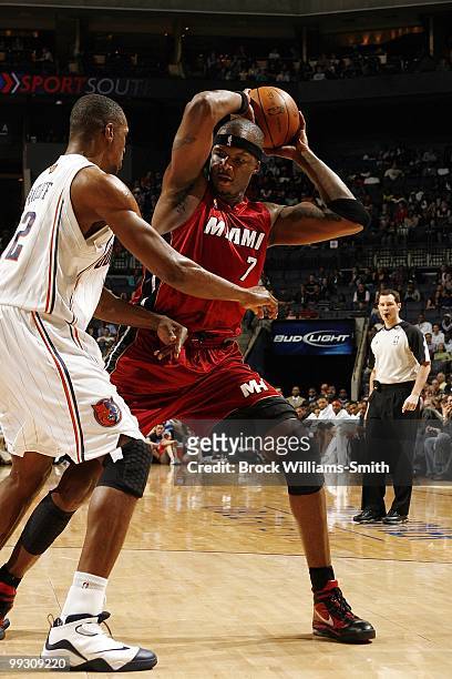 Jermaine O'Neal of the Miami Heat looks to make a play against Theo Ratliff of the Charlotte Bobcats during the game at Time Warner Cable Arena on...