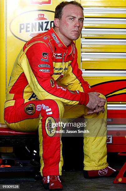 Kevin Harvick, driver of the Shell/Pennzoil Chevrolet, sits in the garage area during practice for the NASCAR Sprint Cup Series Autism Speaks 400 at...