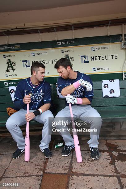 Evan Longoria and Ben Zobrist of the Tampa Bay Rays talking in the dugout prior to the game against the Oakland Athletics at the Oakland Coliseum on...