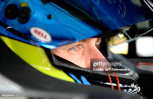Carl Edwards, driver of the Aflac Ford, sits in his car in the garage area during practice for the NASCAR Sprint Cup Series Autism Speaks 400 at...