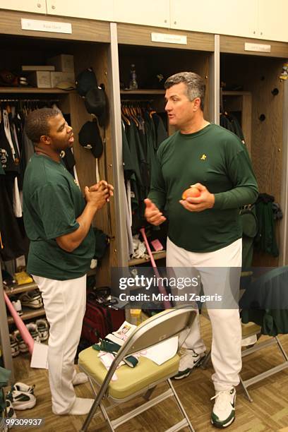 Manager Bob Geren and Rajai Davis of the Oakland Athletics talking in the clubhouse prior to the game against the Tampa Bay Rays at the Oakland...