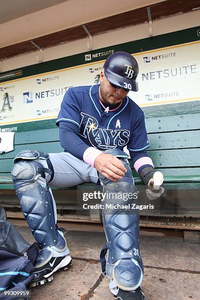 Dioner Navarro of the Tampa Bay Rays putting his pads on prior to the game against the Oakland Athletics at the Oakland Coliseum on May 9, 2010 in...