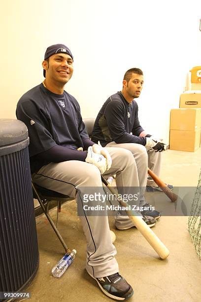 Carlos Pena and Jason Bartlett of the Tampa Bay Rays sitting in the indoor batting cages prior to the game against the Oakland Athletics at the...