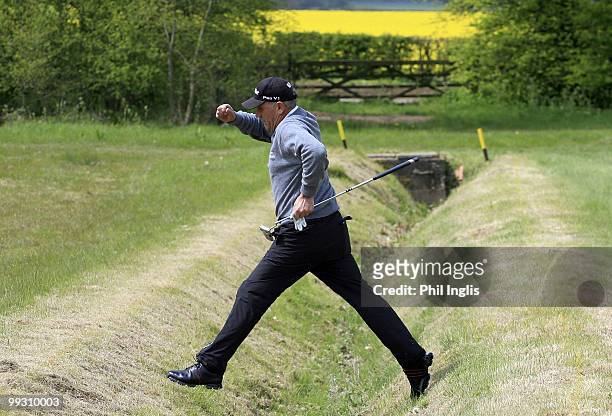 Bill Longmuir of Scotland jumps the ditch on the second hole during the final round of the Handa Senior Masters presented by The Stapleford Forum...