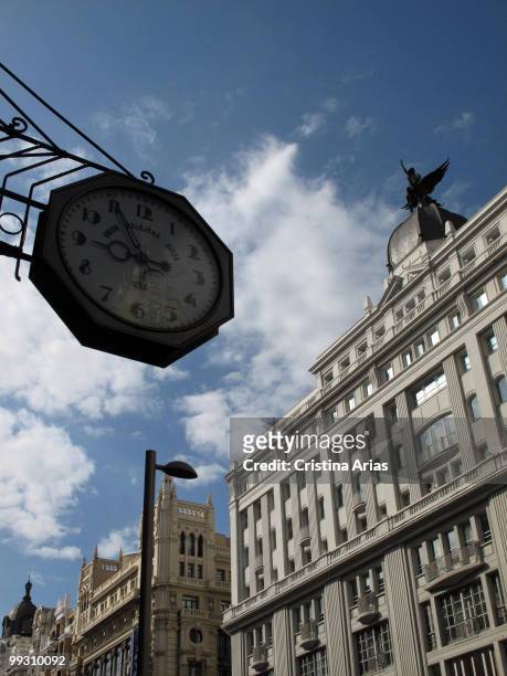 Traditional clock of the Union Relojera Suiza Cia opposite Madrid-Paris building, Gran Via Street, Madrid, Spain, april 2010 .