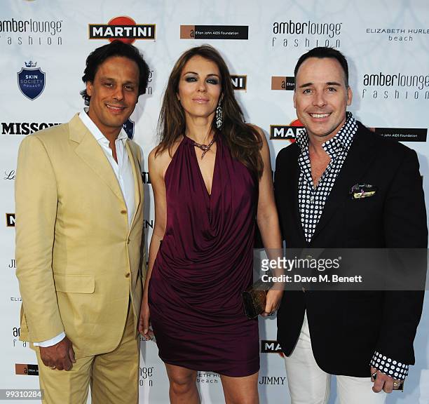 Actress Liz Hurley and husband Arun Nayar are seen with David Furnish while attending the Amber Fashion Show and Auction held at the Meridien Beach...