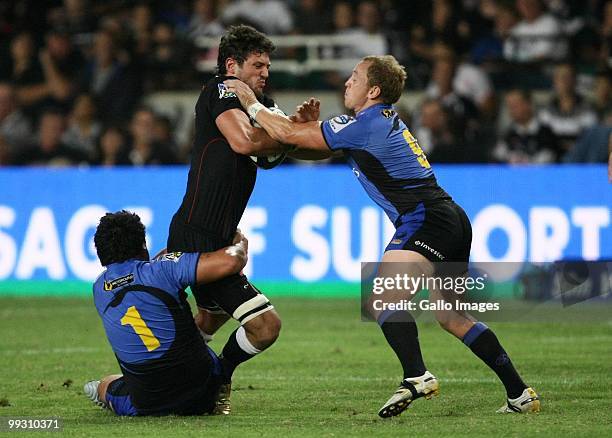 Ryan Kankowski is tackled by Breet Sheehan and Pek Cowan during the Super 14 match between the Sharks and Western Force held at Absa Stadium on May...