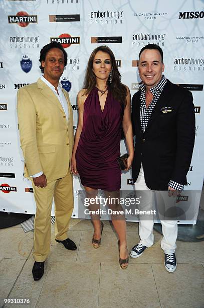 Actress Liz Hurley and husband Arun Nayar are seen with David Furnish while attending the Amber Fashion Show and Auction held at the Meridien Beach...