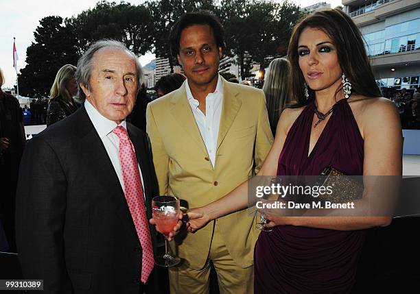 Actress Liz Hurley and husband Arun Nayar talk with Sir Jackie Stewart while attending the Amber Fashion Show and Auction held at the Meridien Beach...