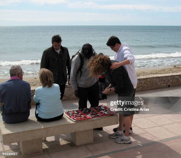 Illegal sale of falsified watches and sunglasses, Cambrils beach, Spain, .