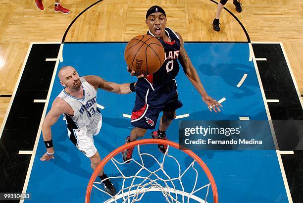 Jeff Teague of the Atlanta Hawks lays the ball up over Marcin Gortat of the Orlando Magic in Game One of the Eastern Conference Semifinals during the...