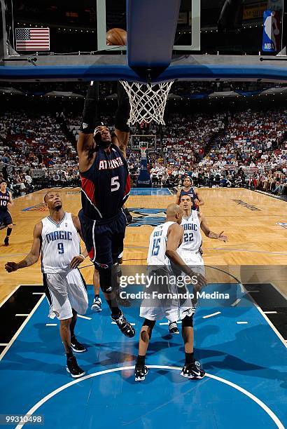 Josh Smith of the Atlanta Hawks slam dunks over Rashard Lewis of the Orlando Magic in Game One of the Eastern Conference Semifinals during the 2010...