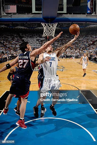 Redick of the Orlando Magic lays the ball up against Zaza Pachulia of the Atlanta Hawks in Game One of the Eastern Conference Semifinals during the...