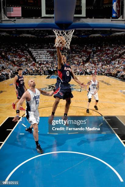 Jeff Teague of the Atlanta Hawks lays the ball up over Marcin Gortat of the Orlando Magic in Game One of the Eastern Conference Semifinals during the...