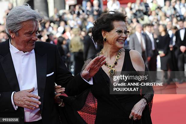 French actor Alain Delon arrives with Italian actress Claudia Cardinale for the screening of "Il Gattopardpo" presented during a special screening at...