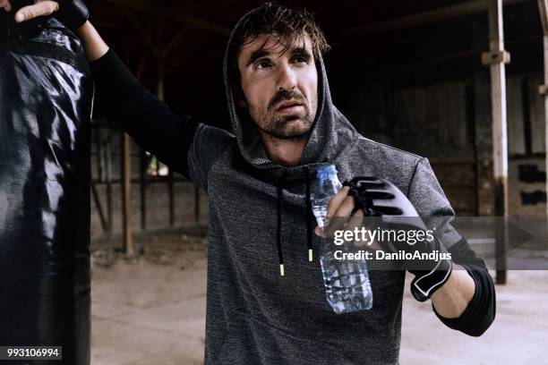 young man taking refreshments after training - kicking tire stock pictures, royalty-free photos & images