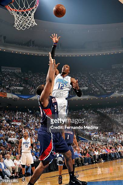 Dwight Howard of the Orlando Magic puts a shot up over Jason Collins of the Atlanta Hawks in Game One of the Eastern Conference Semifinals during the...
