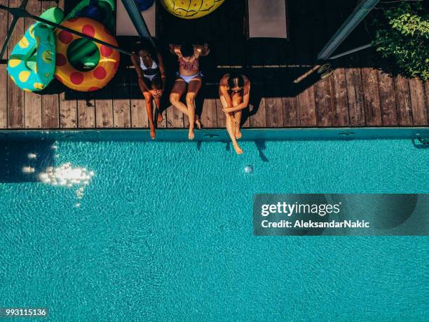 relaxing by the pool - swimming pool top view stock pictures, royalty-free photos & images