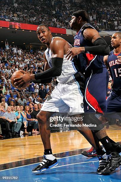 Dwight Howard of the Orlando Magic looks to shoot over Josh Smith of the Atlanta Hawks in Game One of the Eastern Conference Semifinals during the...