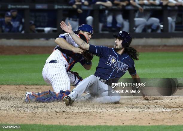 Hunter Wood of the Tampa Bay Rays is out at home with Devin Mesoraco of the New York Mets applying the tag in the ninth inning during their game at...