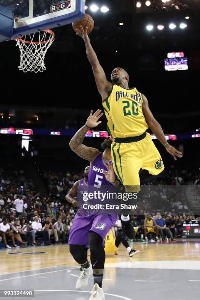 Andre Owens of Ball Hogs goes up for a shot against Carlos Boozer of Ghost Ballers during week three of the BIG3 three on three basketball league...