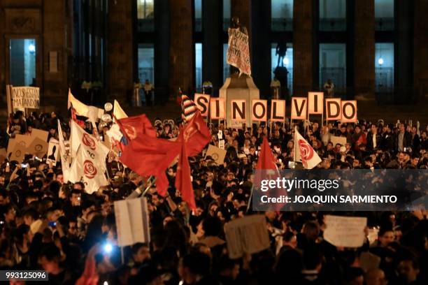 Colombians hold letters forming the words "Without oblivion" as they protest against the assasination of social leaders at the Bolivar square in...