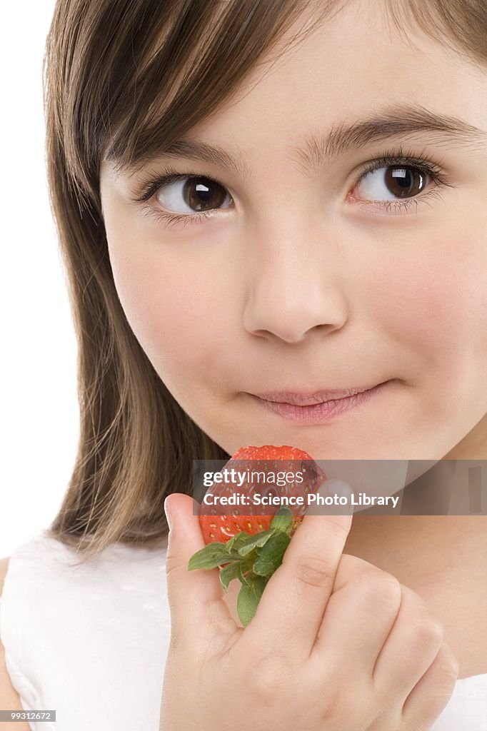 Girl eating a strawberry