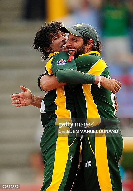 Pakistani bowler Mohammad Aamer celebrates with captain Shahid Afridi after taking the wicket of Australian batsman Cameron White during the ICC...