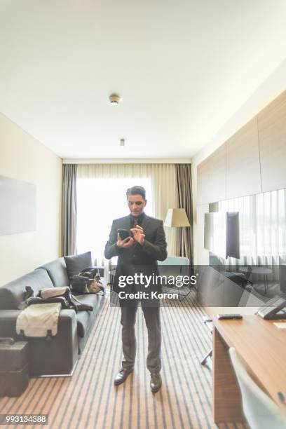 man using smartphone in a hotel - lonely hearts stock pictures, royalty-free photos & images