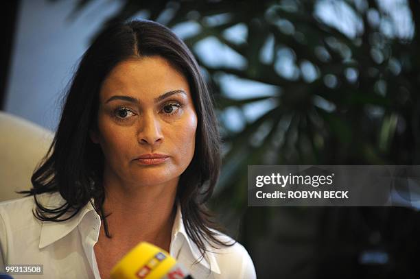 Charlotte Lewis, an actress from London, listens to her lawyer's statement at a press conference in Los Angeles May 14, 2010. Lewis, who appeared in...