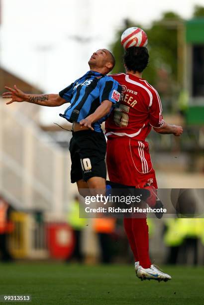 Gordon Greer of Swindon wins a header against Dean Burton of Charlton during the Coca-Cola League One Playoff Semi Final 1st leg match between...