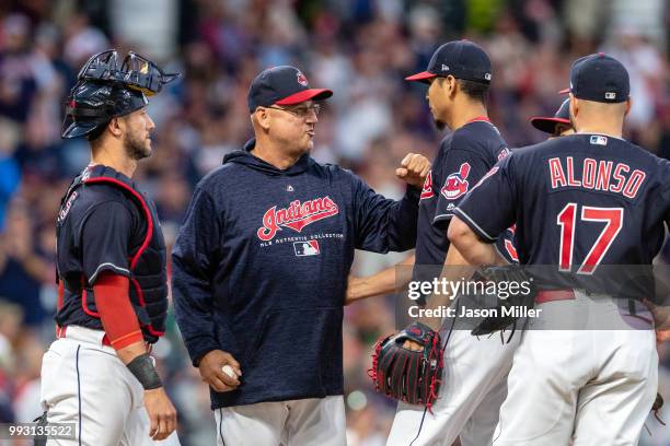 Manager Terry Francona congratulates starting pitcher Carlos Carrasco of the Cleveland Indians as Francona removes Carrasco from the game during the...